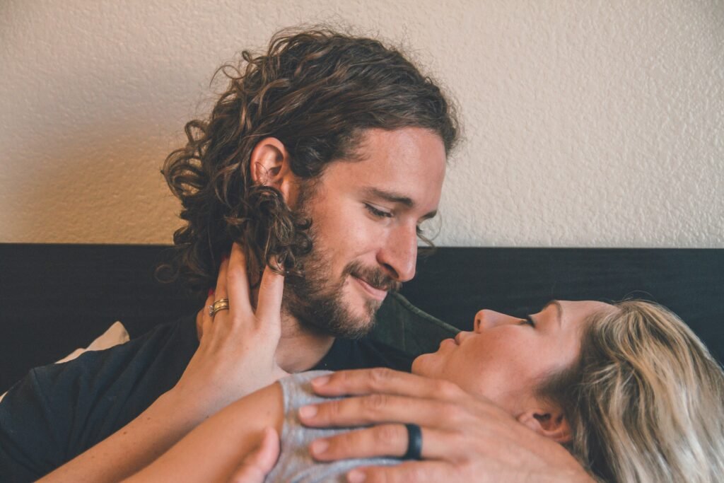 Couple cuddling and practicing emotional aftercare after intimacy.